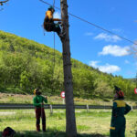 jóvenes practicando la escalada de un árbol bajo la supervisión de instructores de sustraimendi